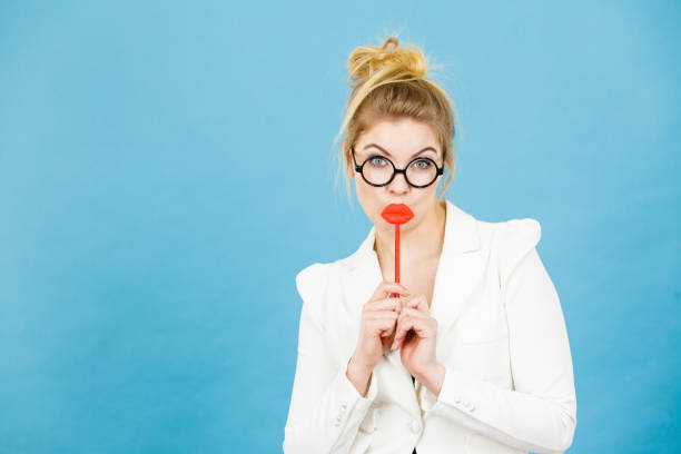 istock Happy woman holding fake lips on stick 874703944