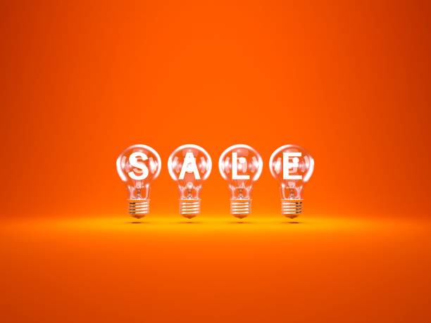 istock Sale and shopping concept. Light bulbs isolated on orange 874704136