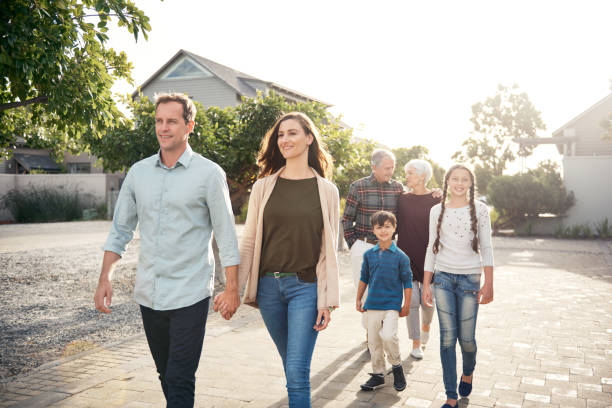 istock mom and dad walking together 874711926