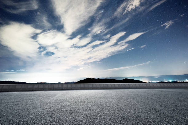 istock empty rural asphalt road with green hill in star sky 874712008