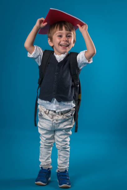 istock Happy little school boy over colored background 874716558