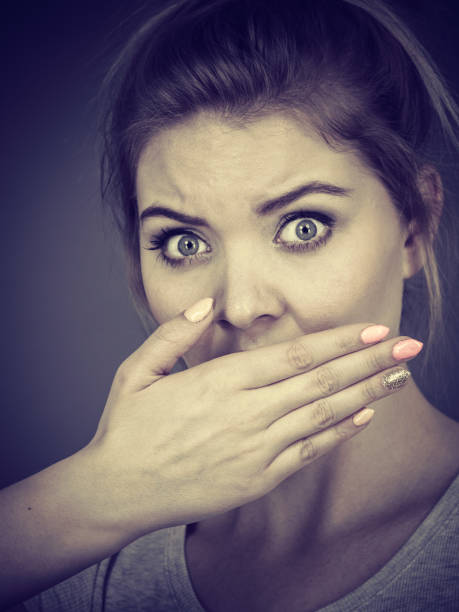 istock Woman covering her mouth with hand 874719142