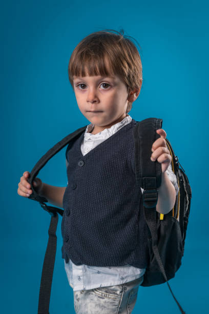 istock little school boy over colored background 874719654