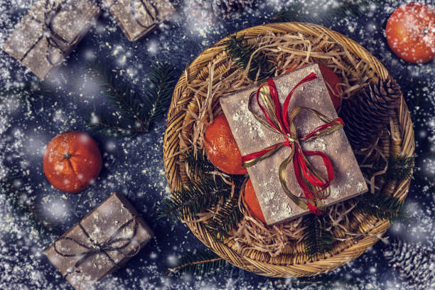 istock Christmas composition with tangerines, gift boxes, cones on dark  background. 874723072