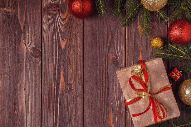 istock Christmas gift boxes and fir tree  on wooden background 874723122