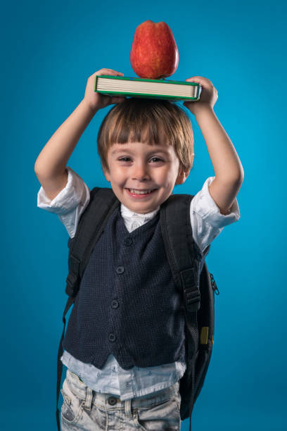 istock Happy little school boy over colored background 874723860