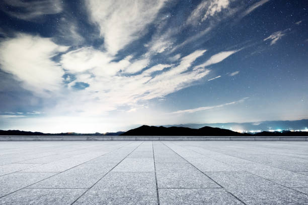 istock empty marble floor with green hill in star sky 874724178