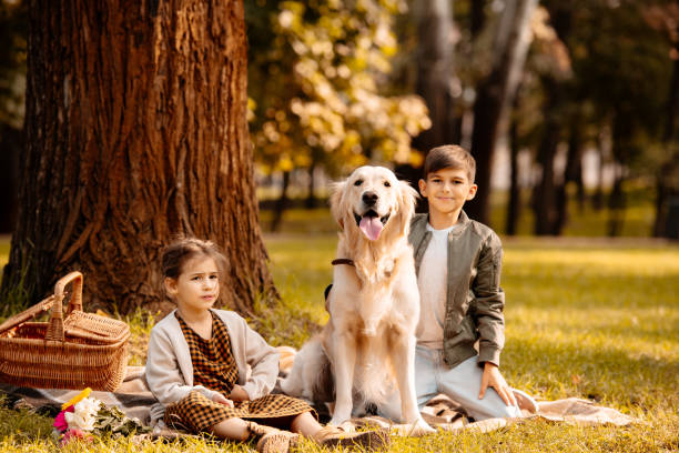 istock children and dog in park 874724308