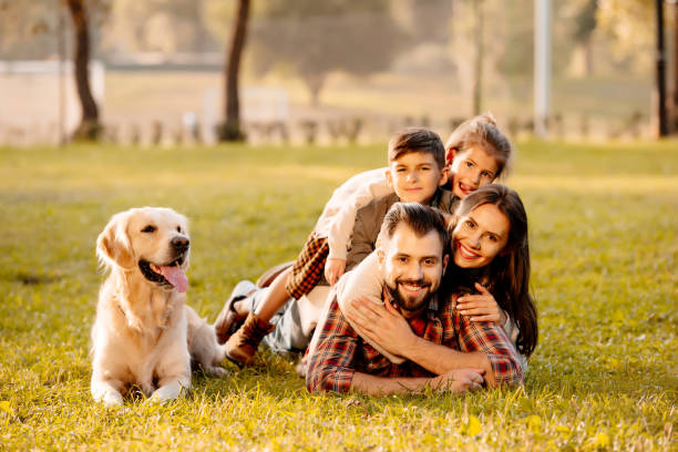istock family lying in pile on grass 874730562