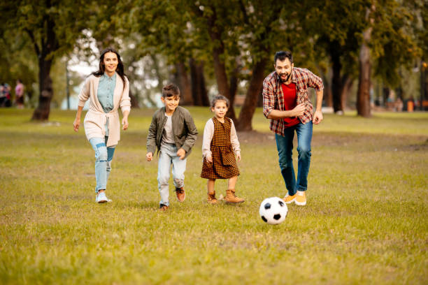 istock Family playing football 874730994