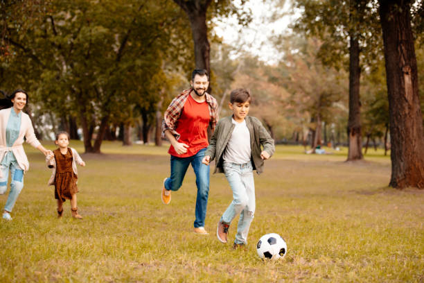 istock Family playing soccer 874731028