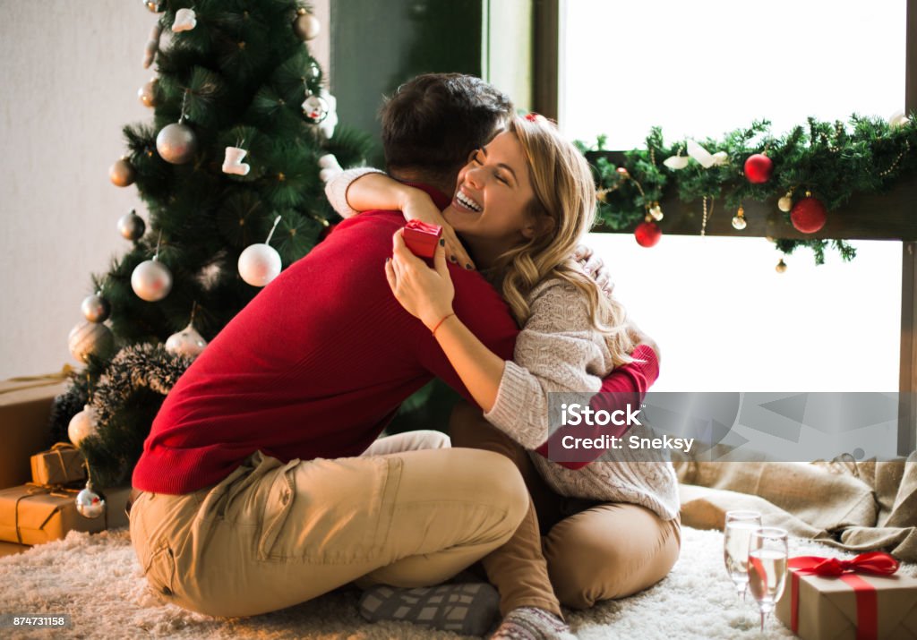 Man surprising his girlfriend on christmas Young man surprising his girlfriend on christmas Christmas Stock Photo