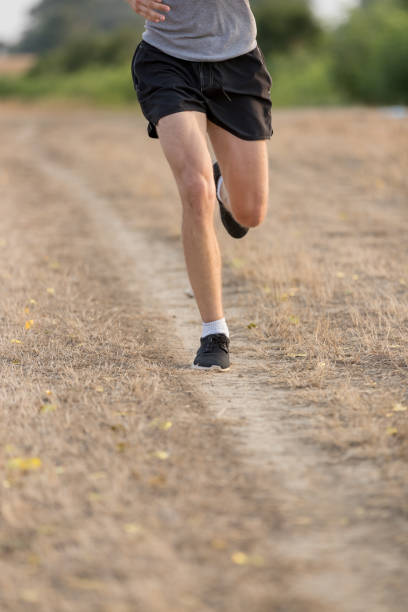 istock Man jogging on dirt road 874731886