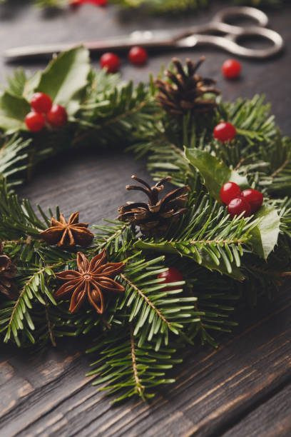 istock Handmde christmas wreath decoration on rustic wood background, vertical 874735036