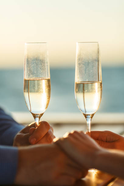 Happy couple drinks champagne on a yacht