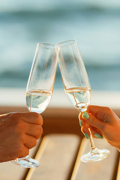 istock Happy couple drinks champagne on a yacht 874735904