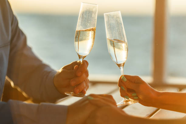 happy couple drinks champagne on a yacht - champagne champagne flute wedding glass imagens e fotografias de stock