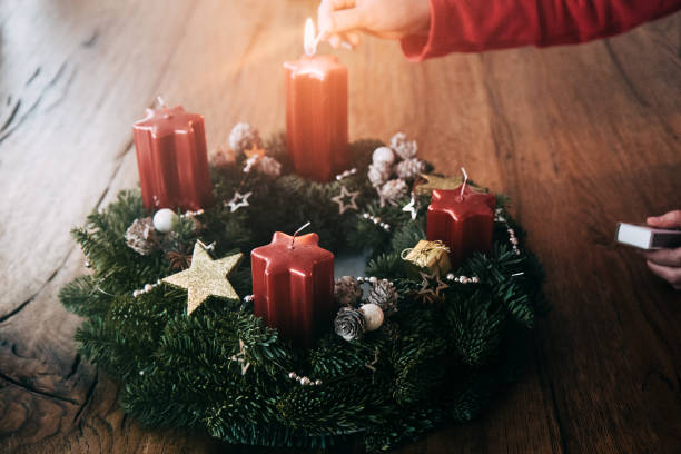 Christmas in GLR Lighting the first candle on Advent wreath four weeks before Christmas as traditionally in Switzerland closeup details advent candles stock pictures, royalty-free photos & images