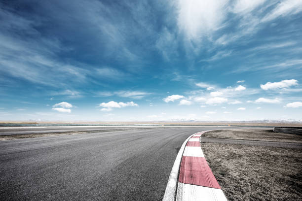 istock empty asphalt road with snow mountains in blue cloud sky 874738524
