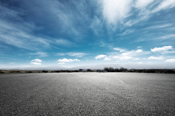istock empty asphalt road with snow mountains in blue cloud sky 874739060