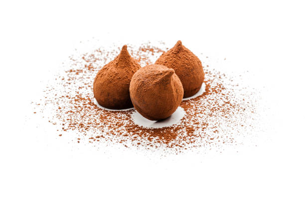 Three chocolate truffles with cocoa powder shot on white background. High key DSRL studio photo taken with Canon EOS 5D Mk II and Canon EF 100mm f/2.8L Macro IS USM