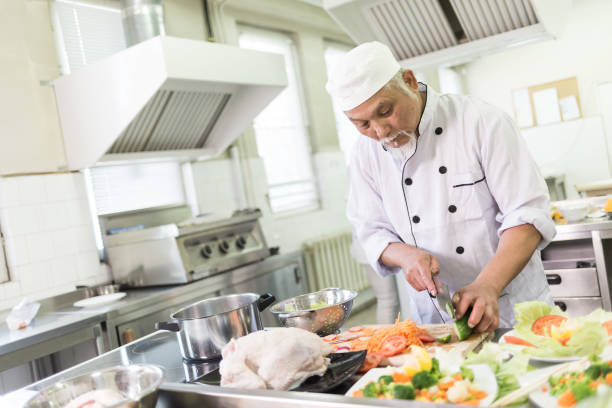 istock Chef preparing fruits and vegetables for salad 874742164