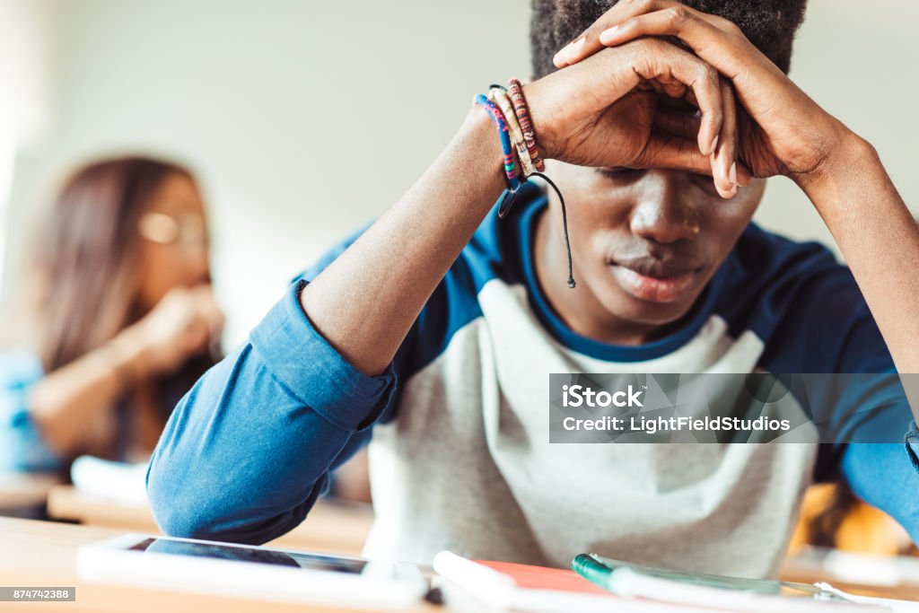 african american student sitting in class depressed young african american student sitting in class Depression - Sadness Stock Photo