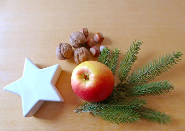 istock Christmas greeting card with apple and nuts 874745026