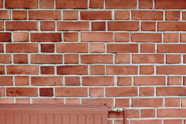 istock Orange brick wall indoor facade with heater detail 874746534
