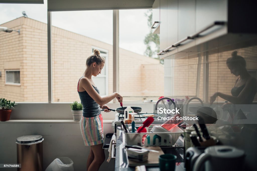 Making Pancakes A young woman makes pancakes for breakfast. Messy Stock Photo