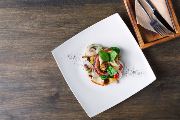 istock Salad with octopus and vegetables top view 874747108