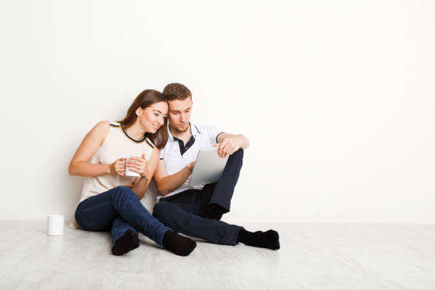 istock Young couple web surfing on laptop 874751830