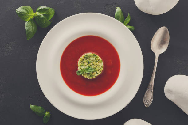 istock Cold tomato soup gazpacho with avocado top view 874753462
