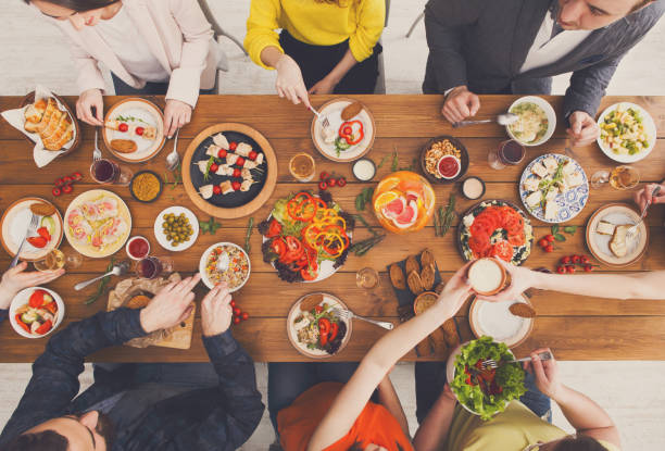 istock People eat healthy meals at served table dinner party 874753888