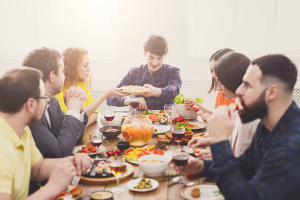 istock Group of people at festive table dinner party 874754222