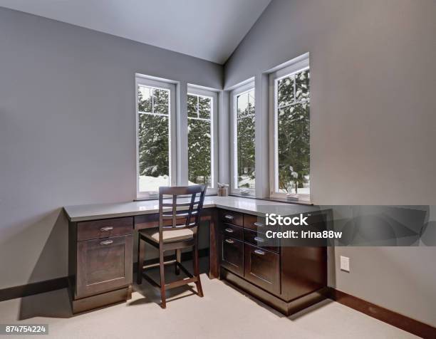 Gray And Blue Home Office Features A Vaulted Ceiling Stock Photo - Download Image Now