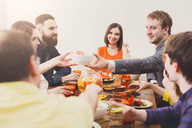 Group of happy people at festive table dinner party
