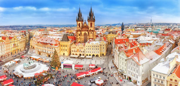 istock Prague in Christmas time. Winter snowy scenery. Classical panoramic view on old Town Square and Tyn church with Christmas fair market in Prague , Czech Republic. New Year festive time. 874754542