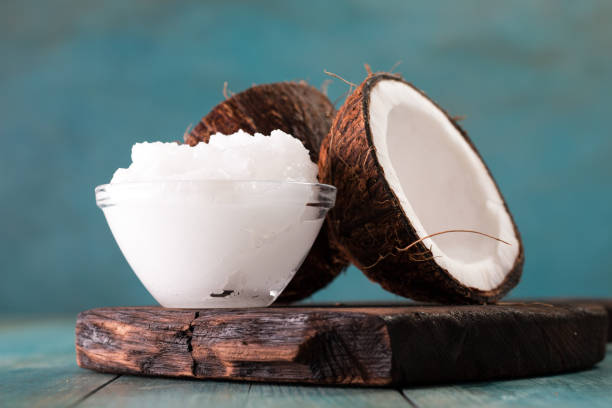 istock coconut oil and fresh coconuts on old wooden table 874756720