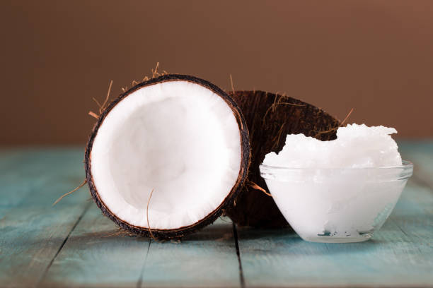 istock coconut oil and fresh coconuts on old wooden table 874757222