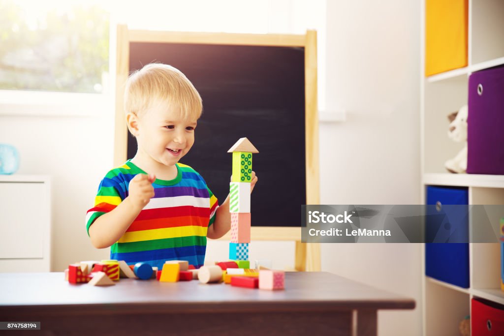 Little child playing with blocks Little child playing with blocks. Boy building towers Child Stock Photo