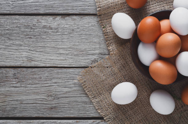 istock Fresh chicken brown eggs on sack, organic farming background 874760898