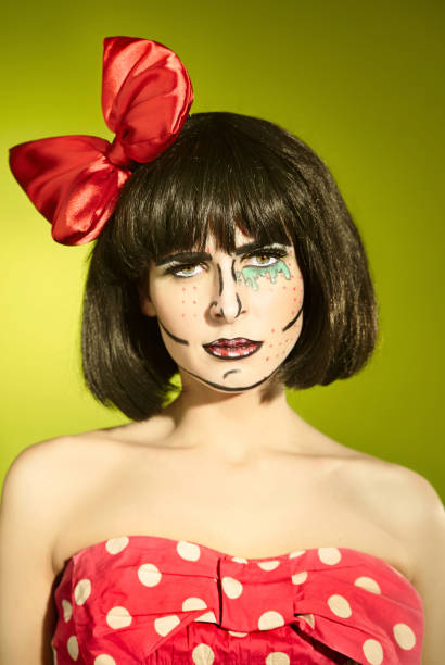 Funny girl with a red bow Portrait of funny mime girl with a red bow in a polka-dot dress pantomime dame stock pictures, royalty-free photos & images