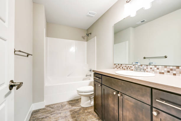 istock White bathroom interior with brown vanity cabinet 874764428