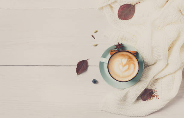 istock Autumn cappuccino coffee cup on white wood background 874764644