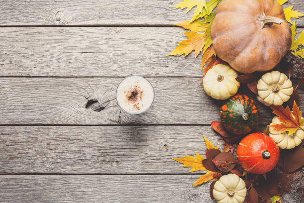 istock Autumn background with yellow leaves and pumpkins 874765114