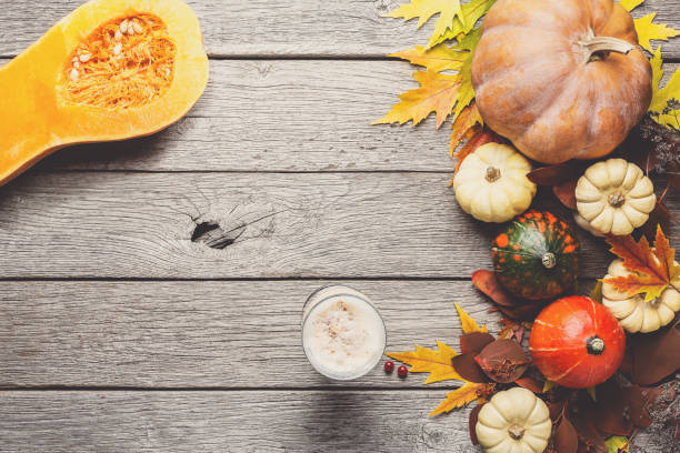 istock Autumn background with yellow leaves and pumpkins 874765194