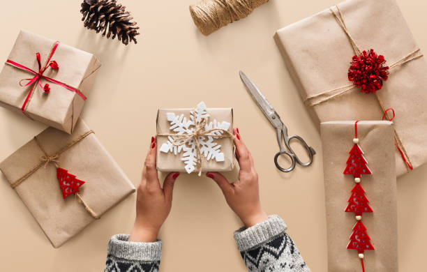 istock Woman's hands holding christmas holiday present decorated with snowflake 874767648