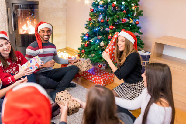 istock Friends giving each other Christmas presents 874768430