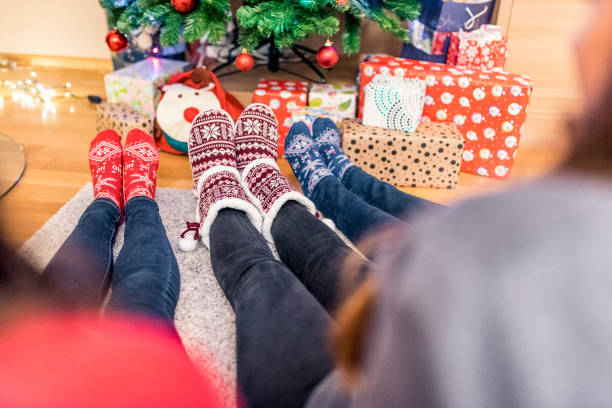 istock Three people wearing christmas socks 874768466